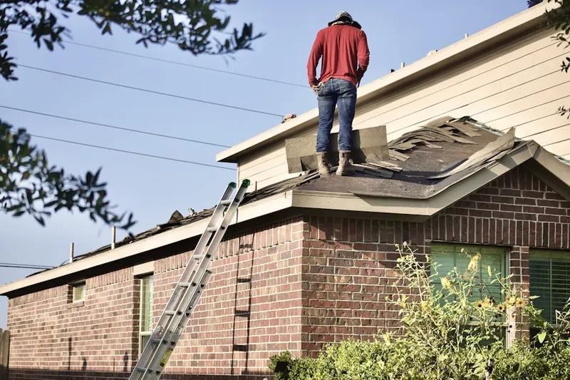 Professional roofer working on a residential roof in Seanor